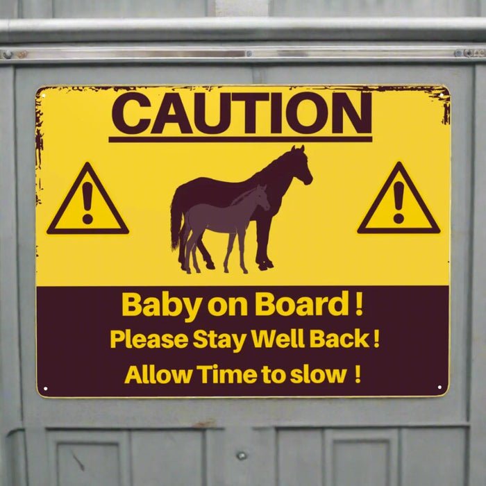 Caution sign with horse illustration and text on a yellow background